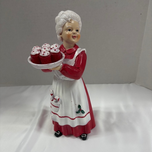 Mrs Claus figurine holding a tray of red cupcakes. - Picture 1 of 7